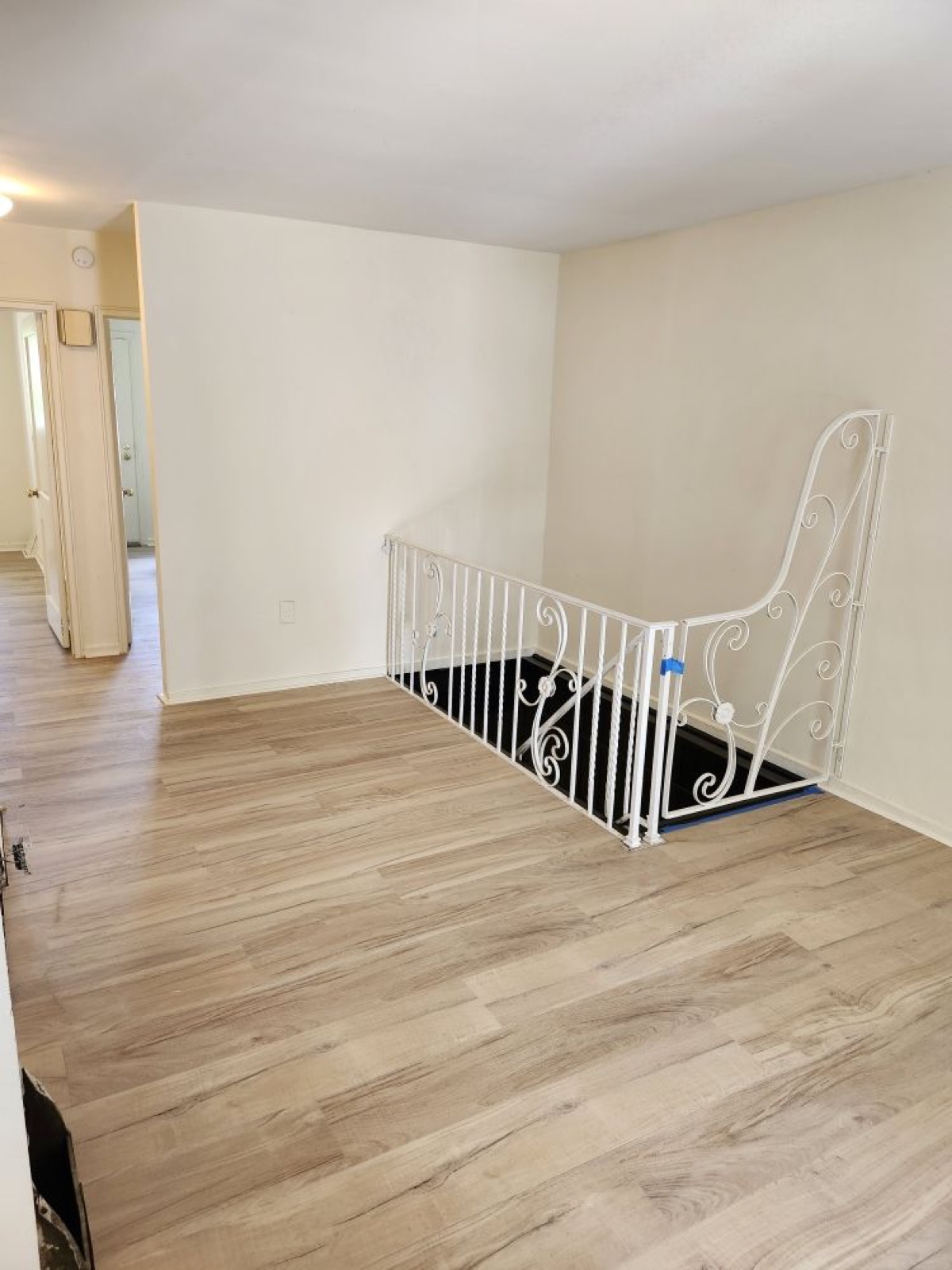 New LVP flooring with white railing upstairs