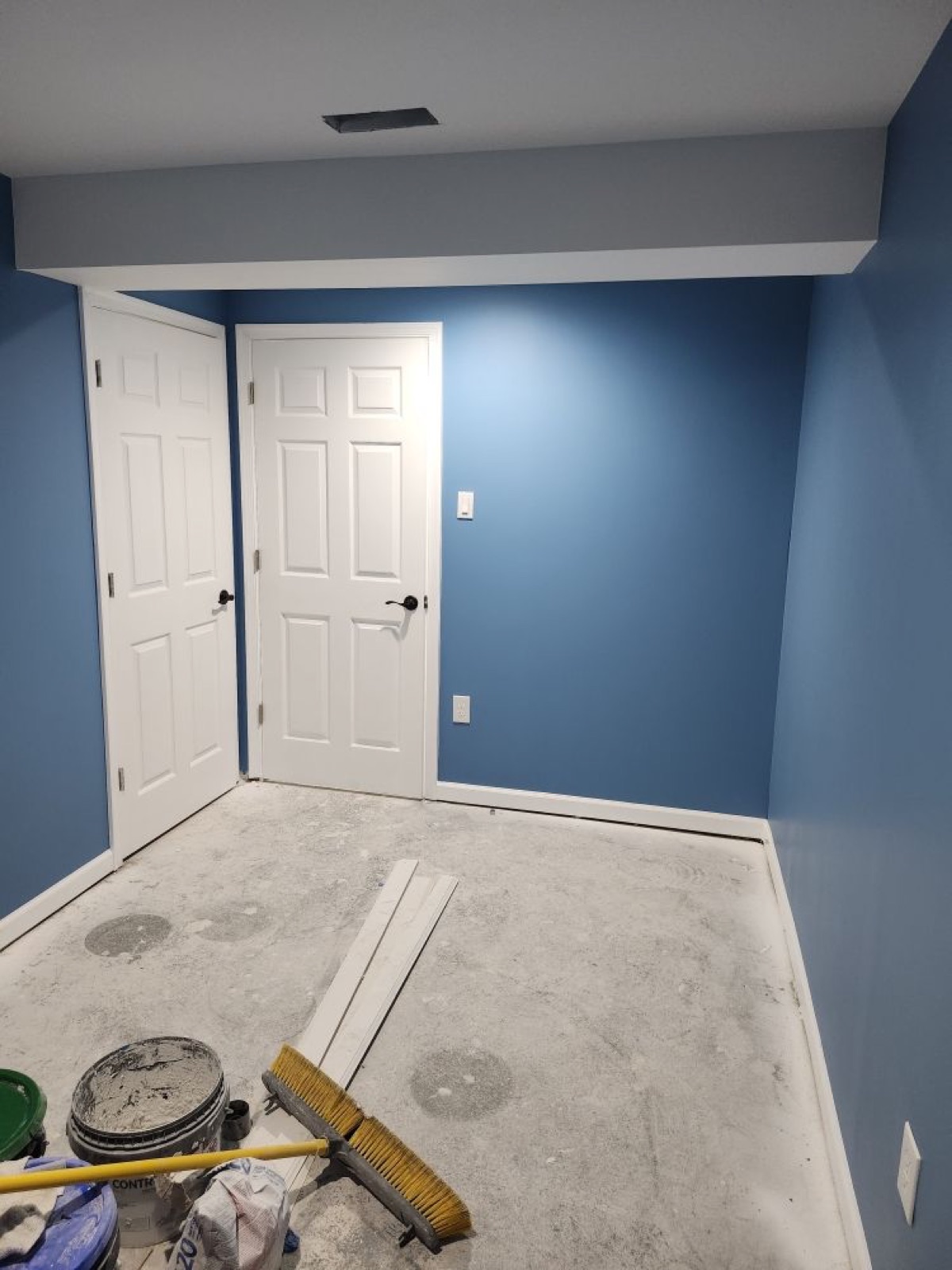 Interior painting with deep blue accent wall and crisp trim