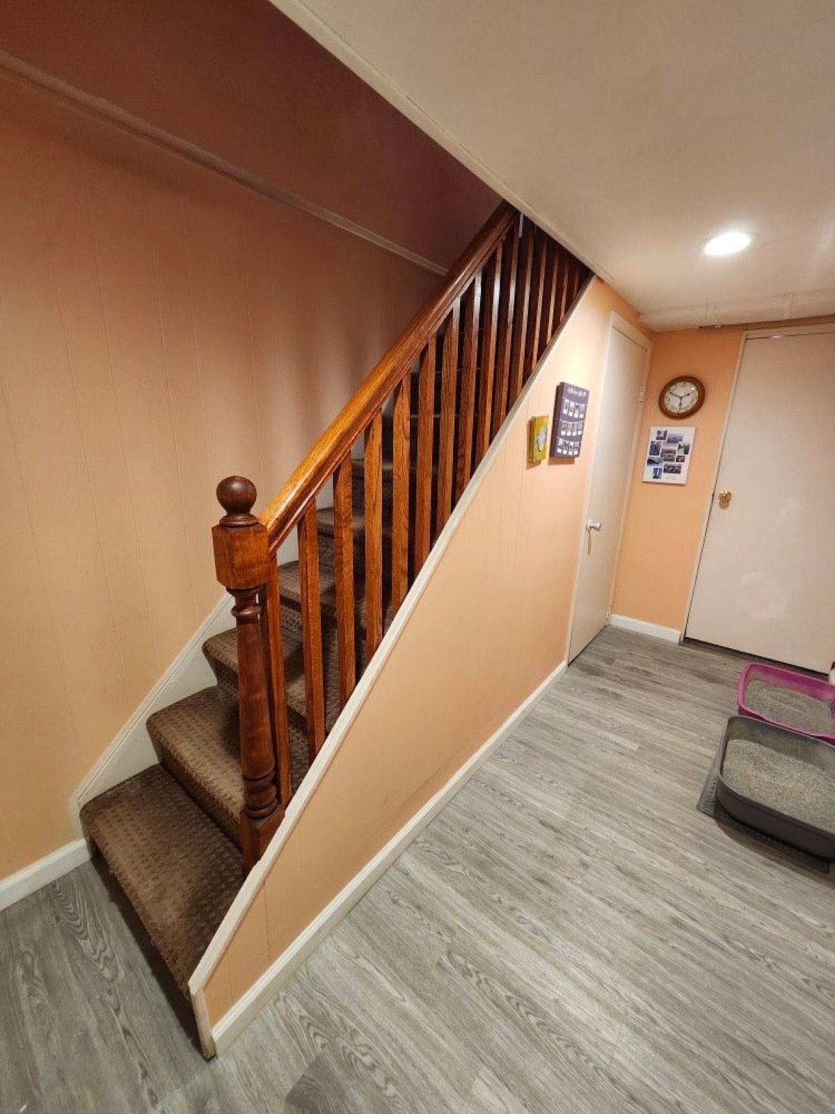 Renovated staircase with wood railing and new flooring